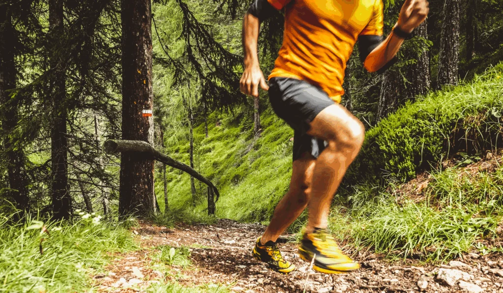 runner running through forest trail
